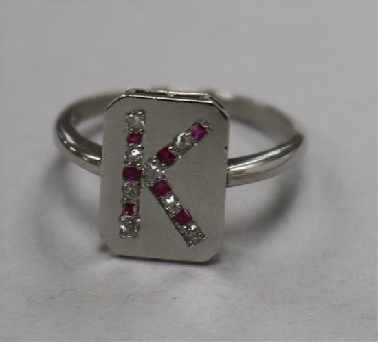 A platinum, ruby and diamond set initial ring, size K.